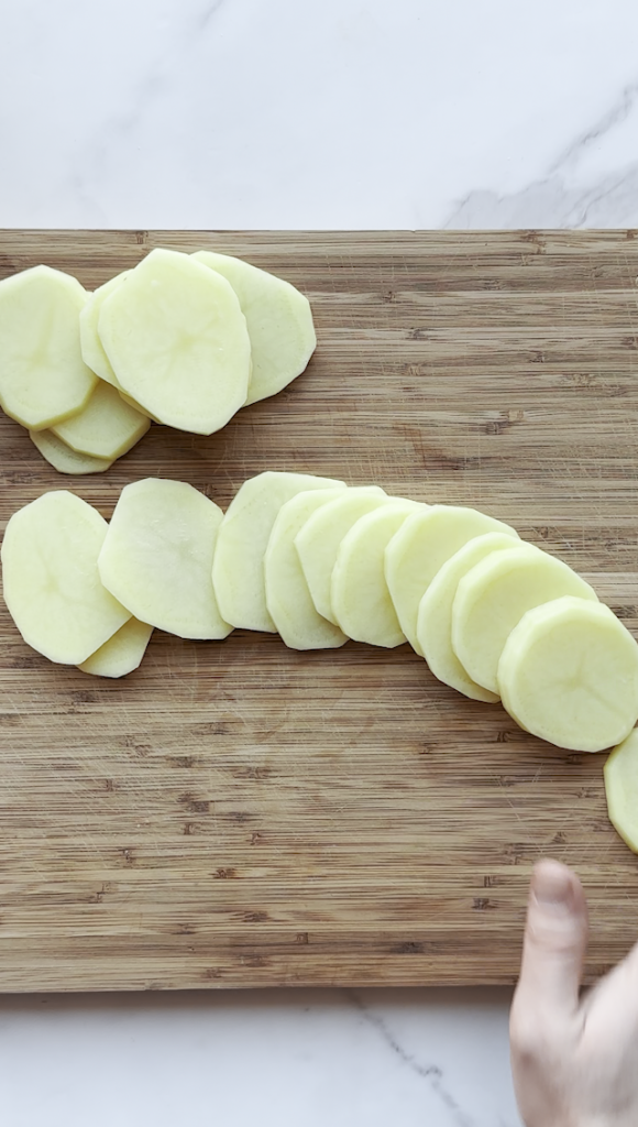 potatoes being cut in thin slices for Afghan Pakawra